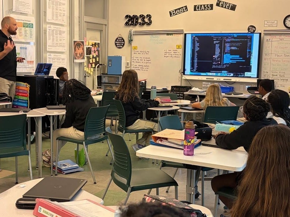 A sixth grade class at Drew Charter School looking at the Flappy Eagle code on the classroom screen